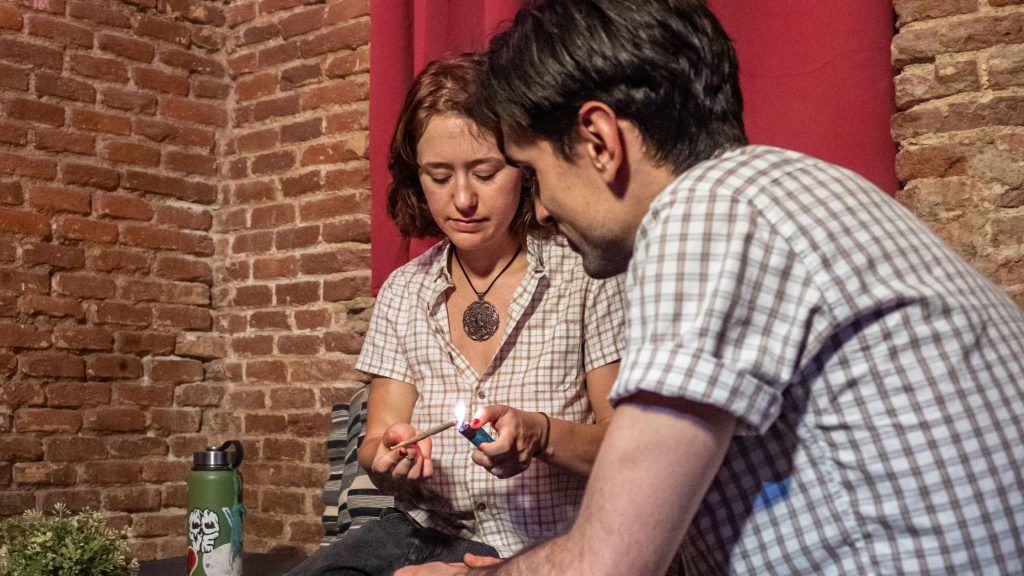 a couple smoking marijuana weed at a cannabis club falcanna in Madrid which is allowed in a legal grey zone. 
